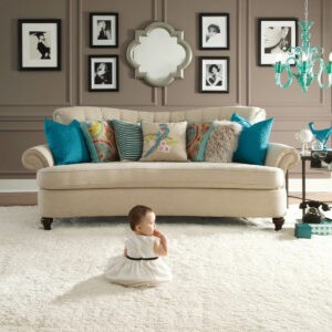 baby sitting on plush carpet in living room | Select Floors