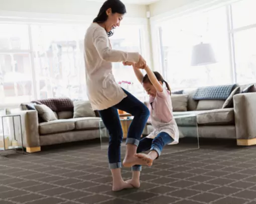 mom and daughter playing on newly installed carpet | Select Floors