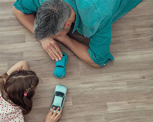 parent and child playing on a vinyl floor | Select Floors