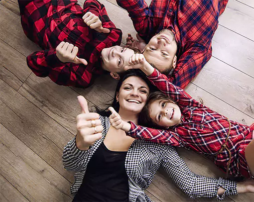 happy family laying on hardwood floors | Select Floors