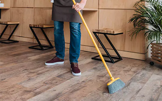 person sweeping hardwood | Select Floors