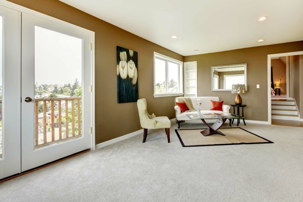 Carpet in a living room with a couch and chair by Select Floors in Marietta, GA.