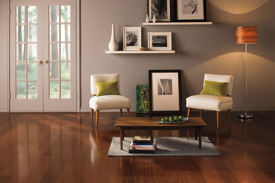 Dark brown laminate flooring in a room with two chairs and a table by Select floors in Marietta, GA.
